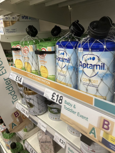 Photo of supermarket shelf with security tags on baby milk