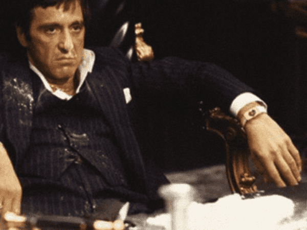Still from Scarface. Al covered in cocaine. 