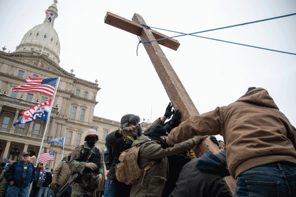 Image of right wing cultist conservatives raising a cross in the style of Iwo Jima in front of the capital