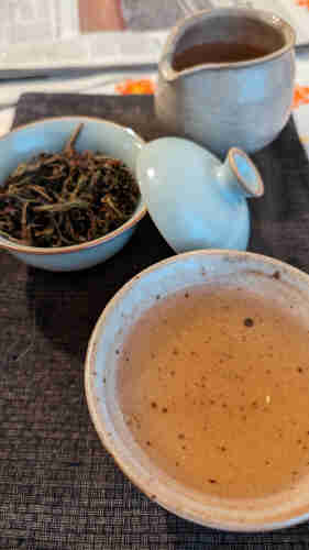 Tea in a bowl, gaiwan, and share cup.