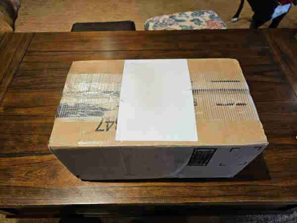 Cardboard box sitting on a coffee table. 