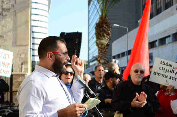 Amjad Shbita speaking to the crowd at a protest.